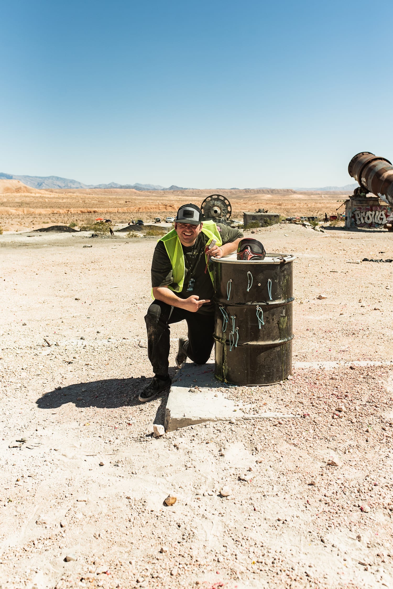 Mike Leavitt kneeling by a barrel objective at a Barrels Up scenario game.